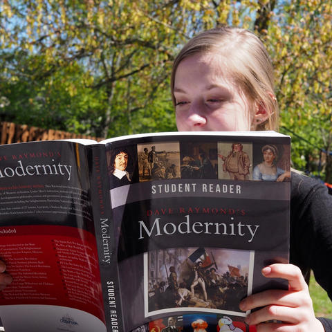 Girl with Modernity book Compass Classroom